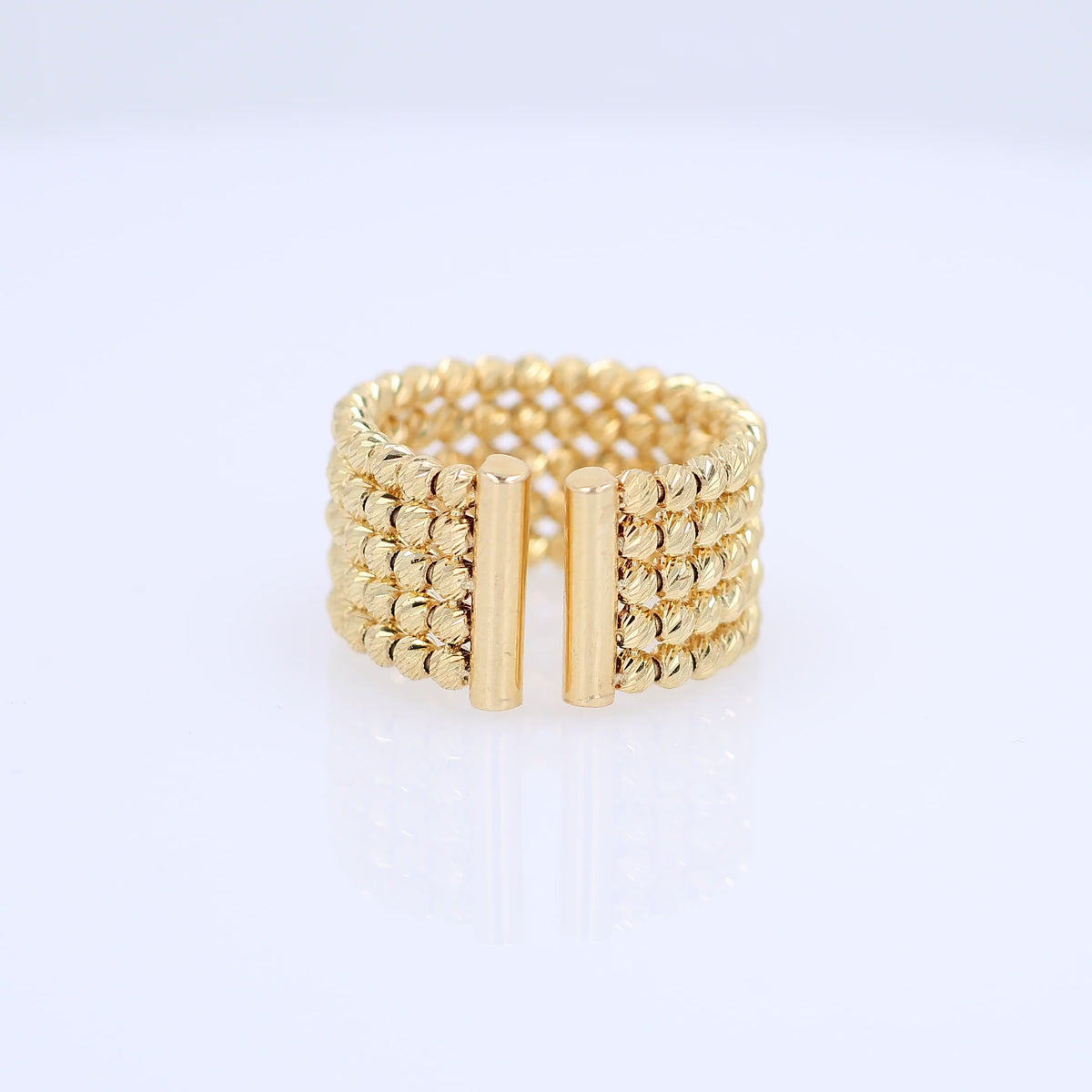 A video of a wide gold-plated multi-row beaded ring with two vertical gold bars in the front, displayed on a clean white background.