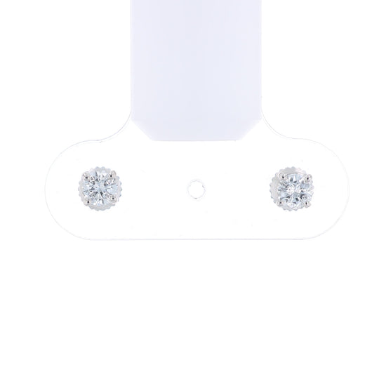 Pair of white gold round diamond stud earrings on a white background