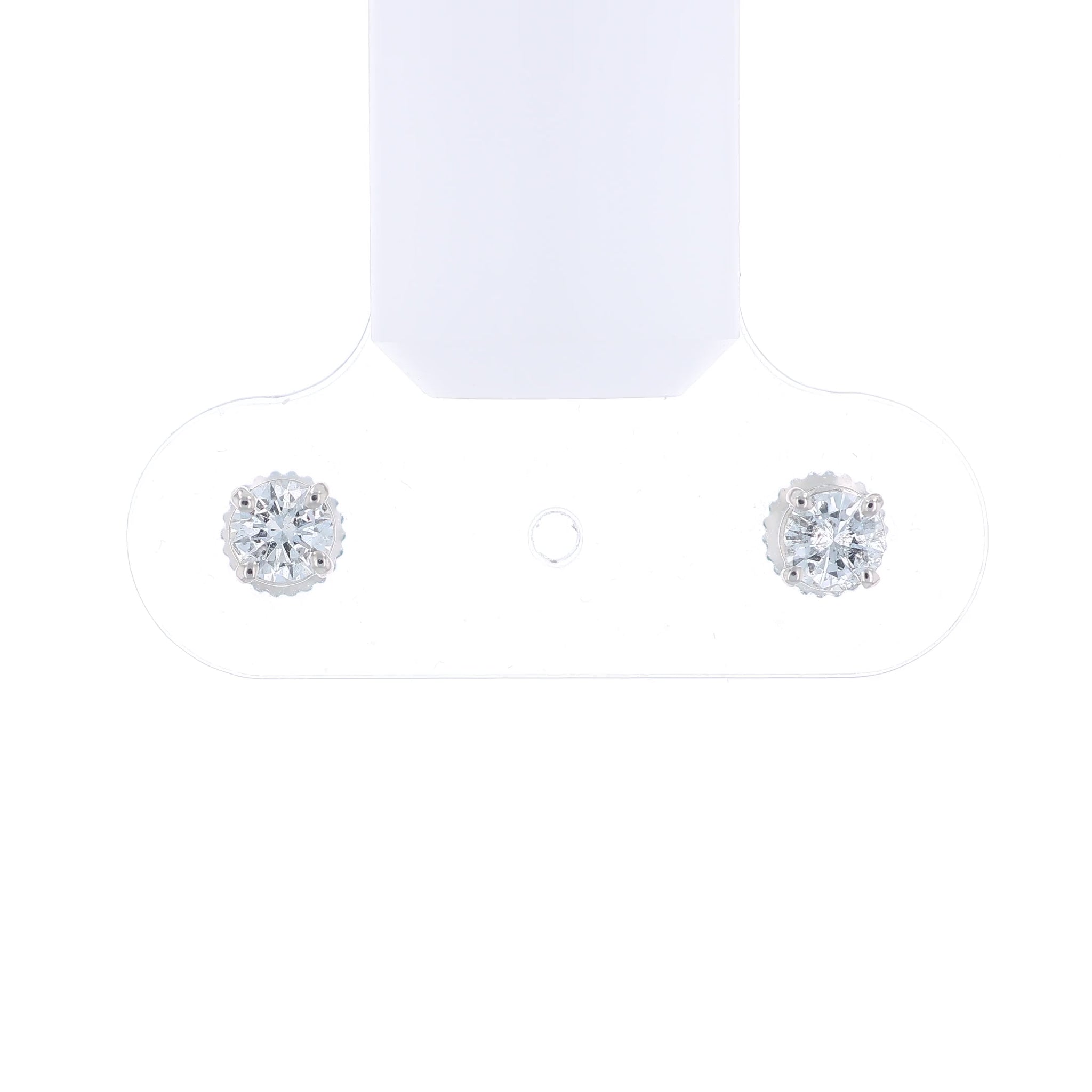 Pair of white gold round diamond stud earrings on a white background