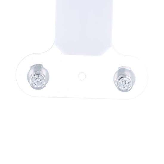 White gold bezel-set diamond stud earrings on a white background