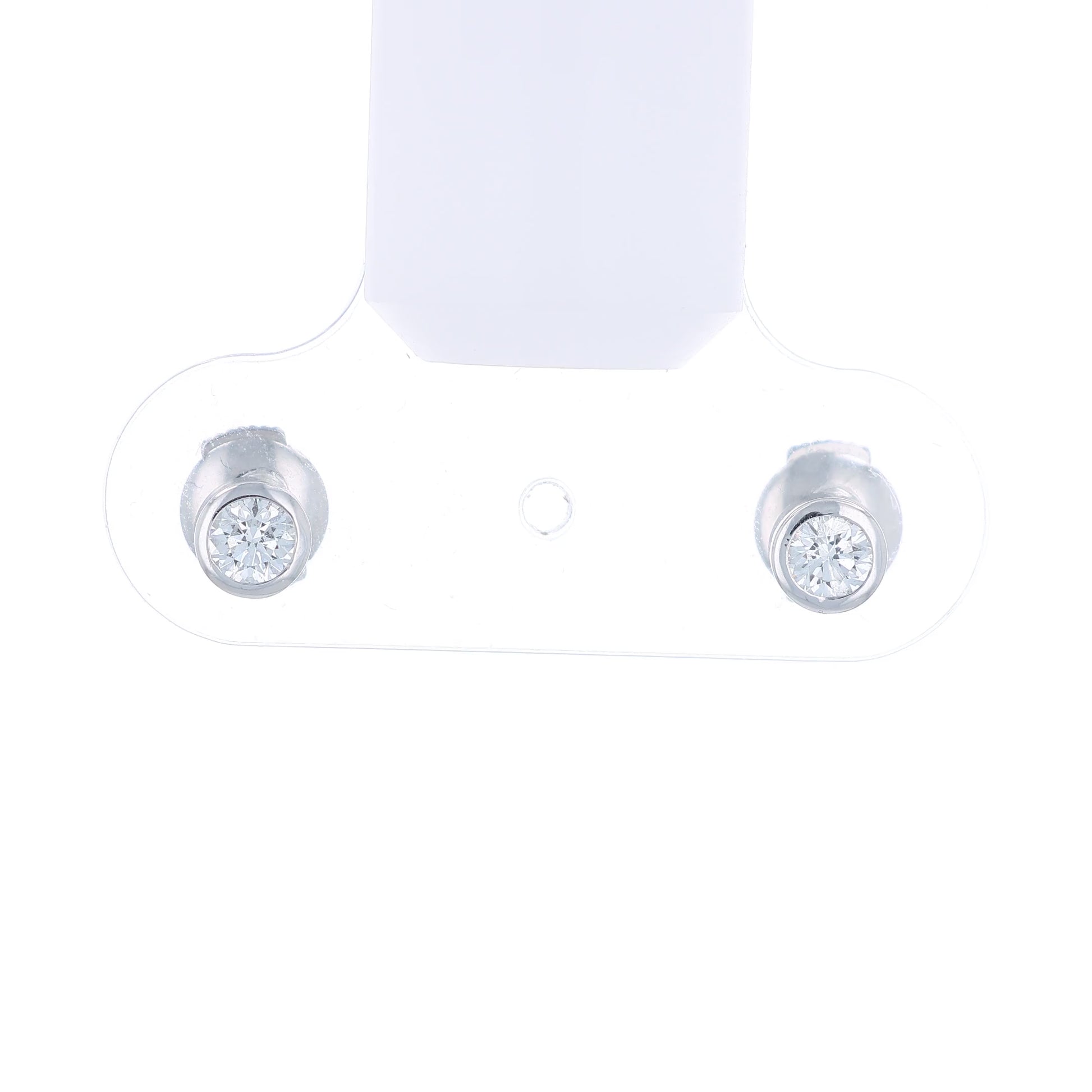 White gold bezel-set diamond stud earrings on a white background