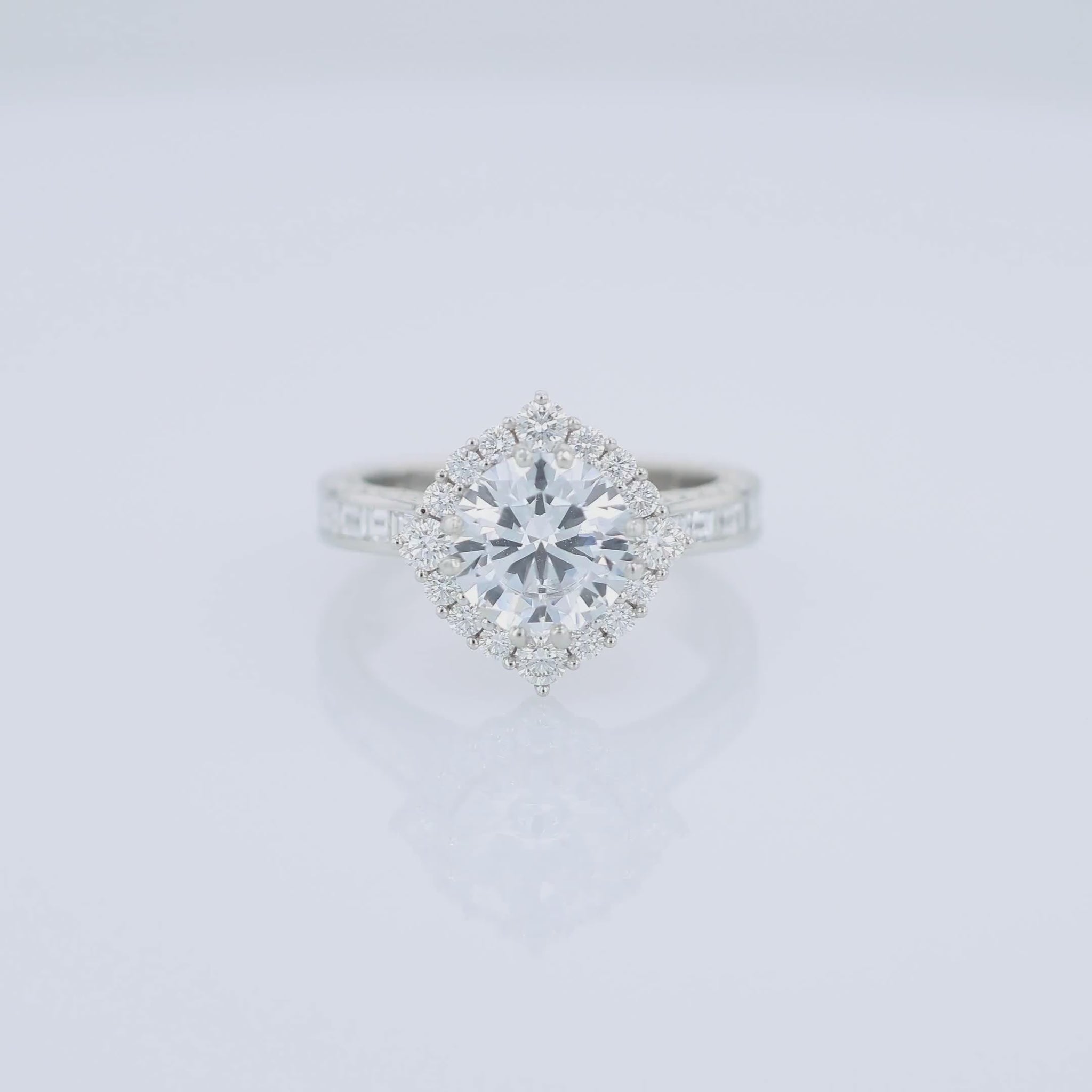 Platinum diamond halo engagement ring with diamond accents and a round cubic zirconia center on a white background