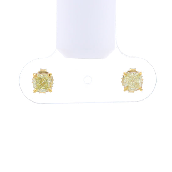 Video of a pair of yellow gold stud earrings with cushion-cut fancy yellow diamonds on a white background