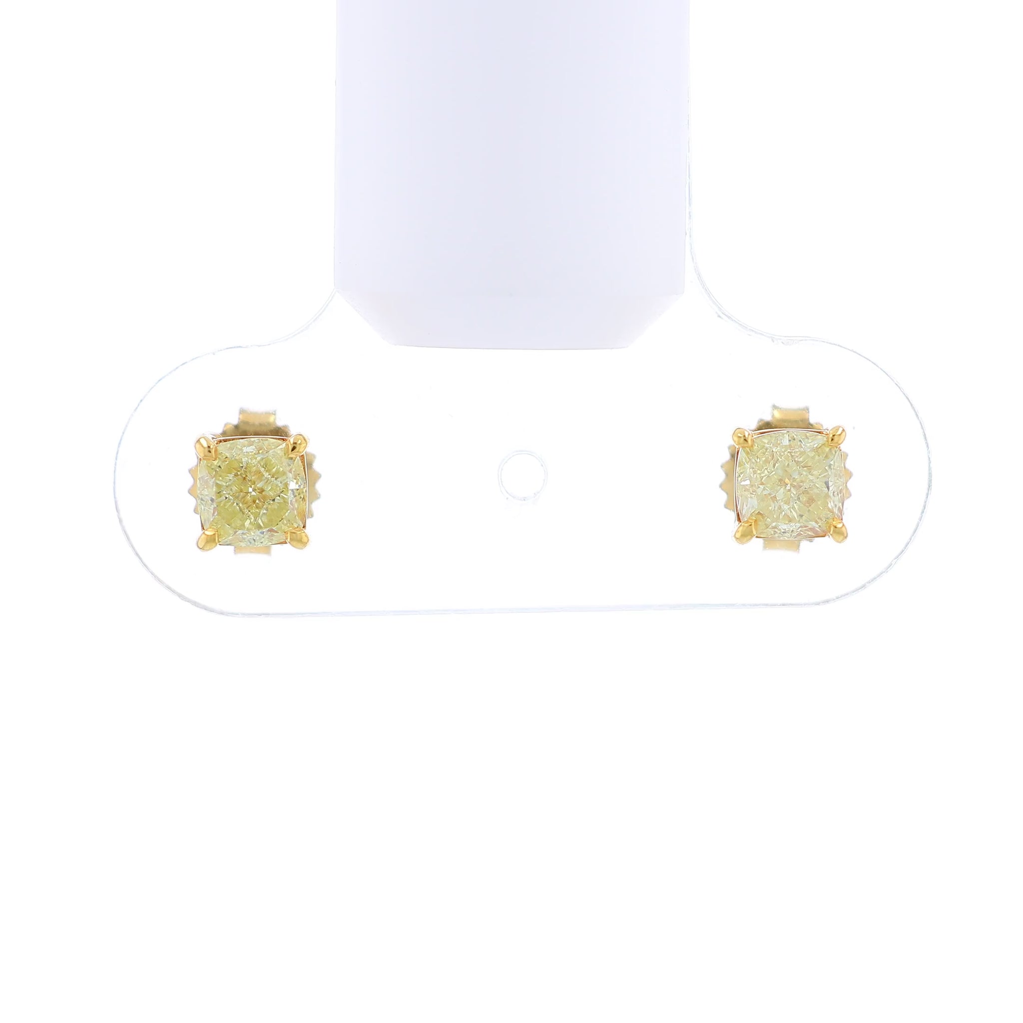 Video of a pair of yellow gold stud earrings with cushion-cut fancy yellow diamonds on a white background