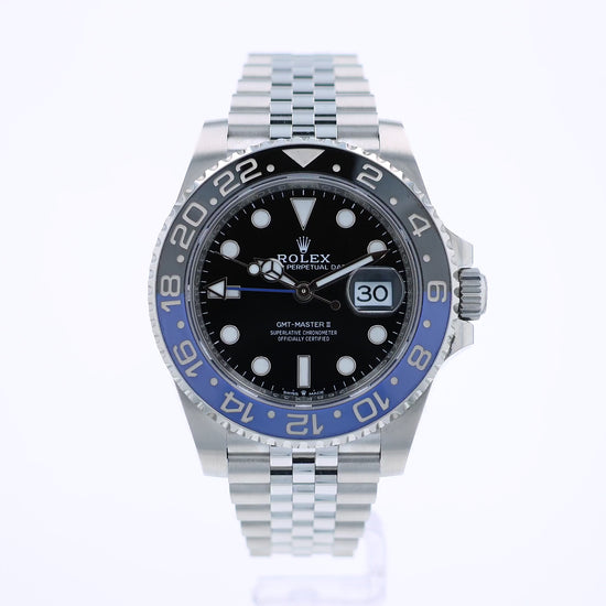 360 degree video of a Rolex watch with a black dial and blue and black bezel on a white background