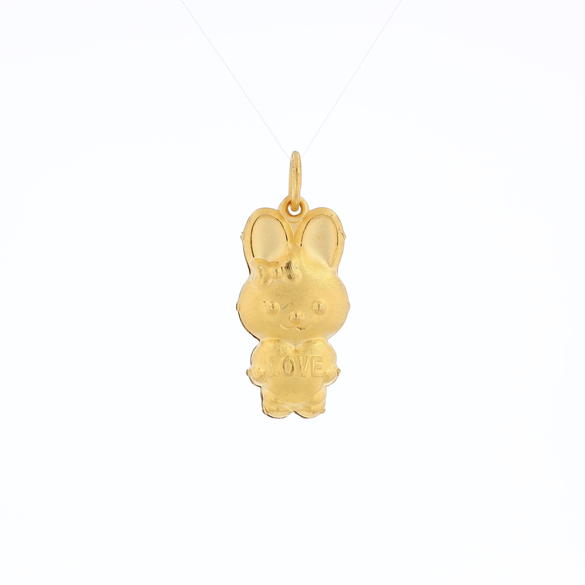 Yellow gold brushed bunny pendant holding a heart reading "LOVE" on a white background