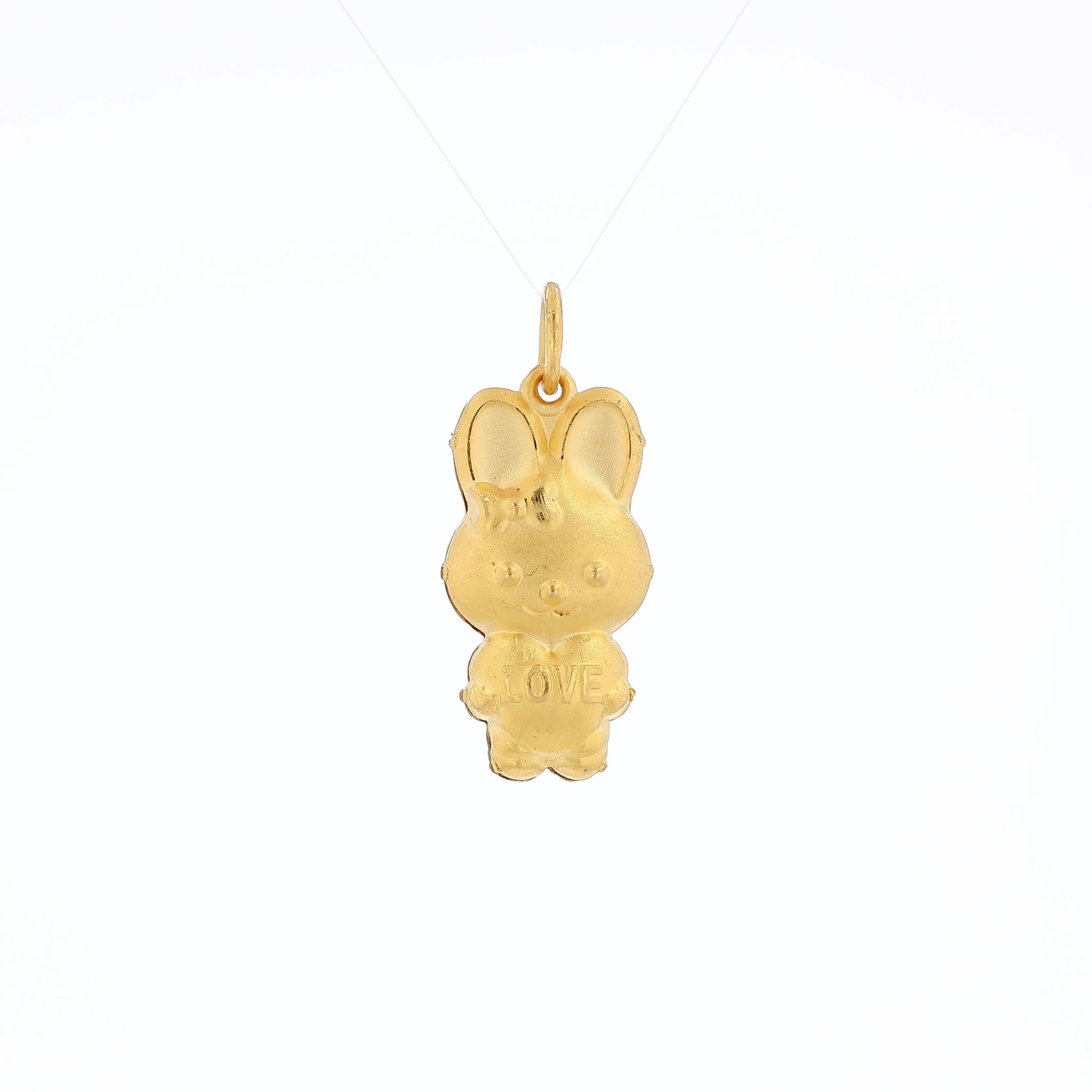 Yellow gold brushed bunny pendant holding a heart reading "LOVE" on a white background