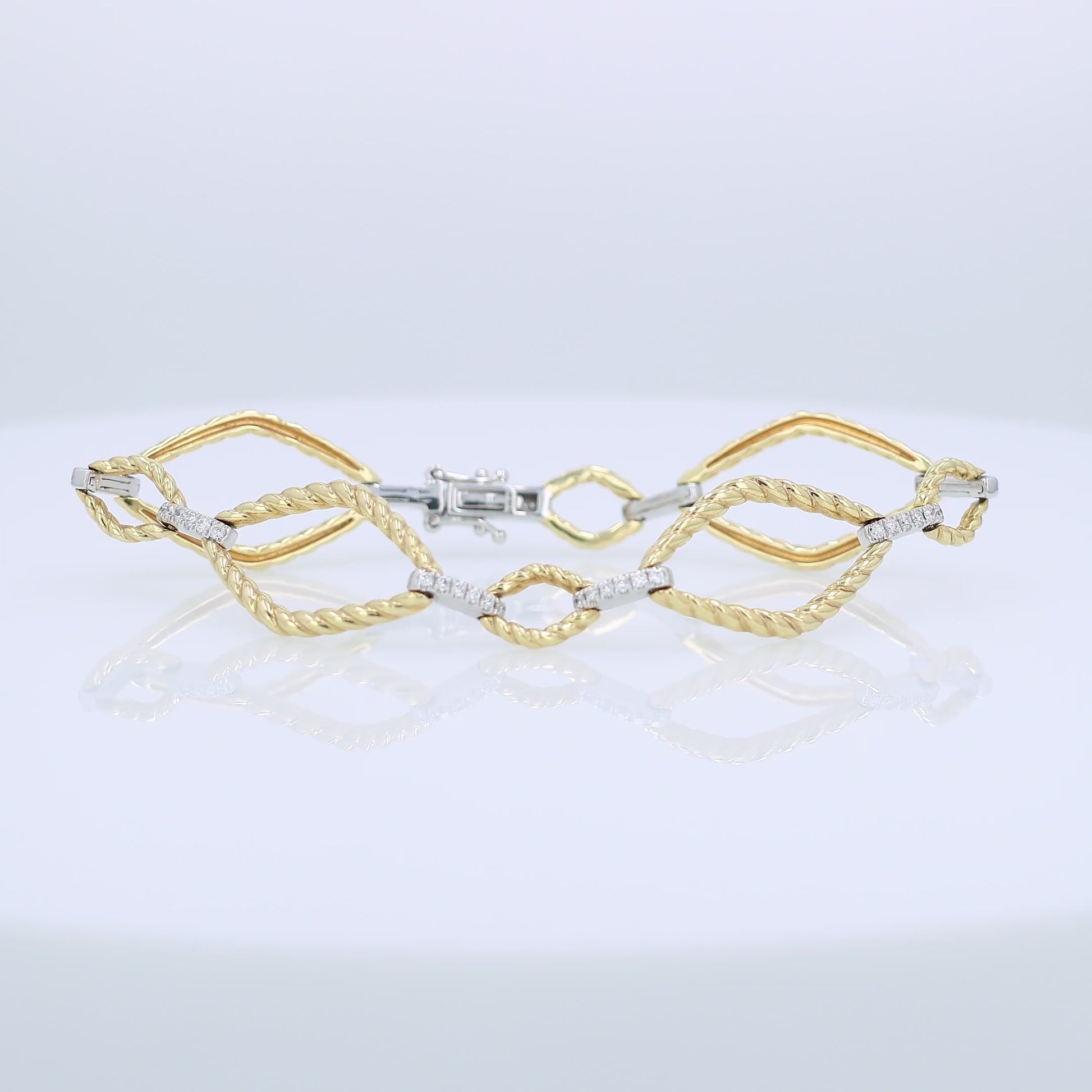 Yellow and white gold alternating open braided link and diamond bar bracelet on a white background