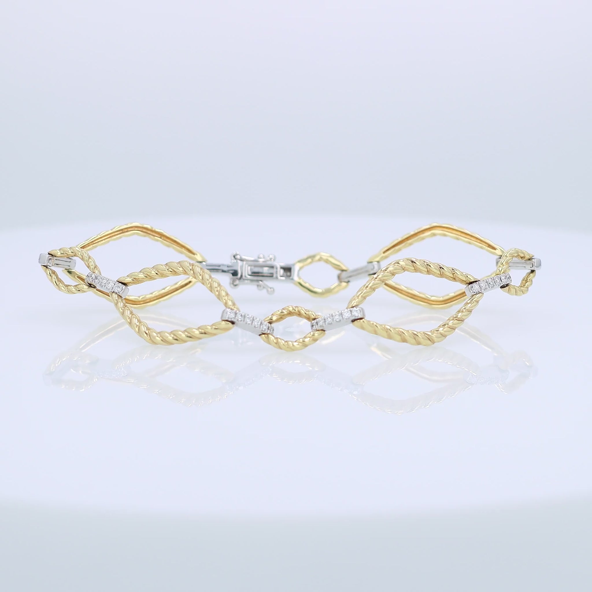 Yellow and white gold alternating open braided link and diamond bar bracelet on a white background