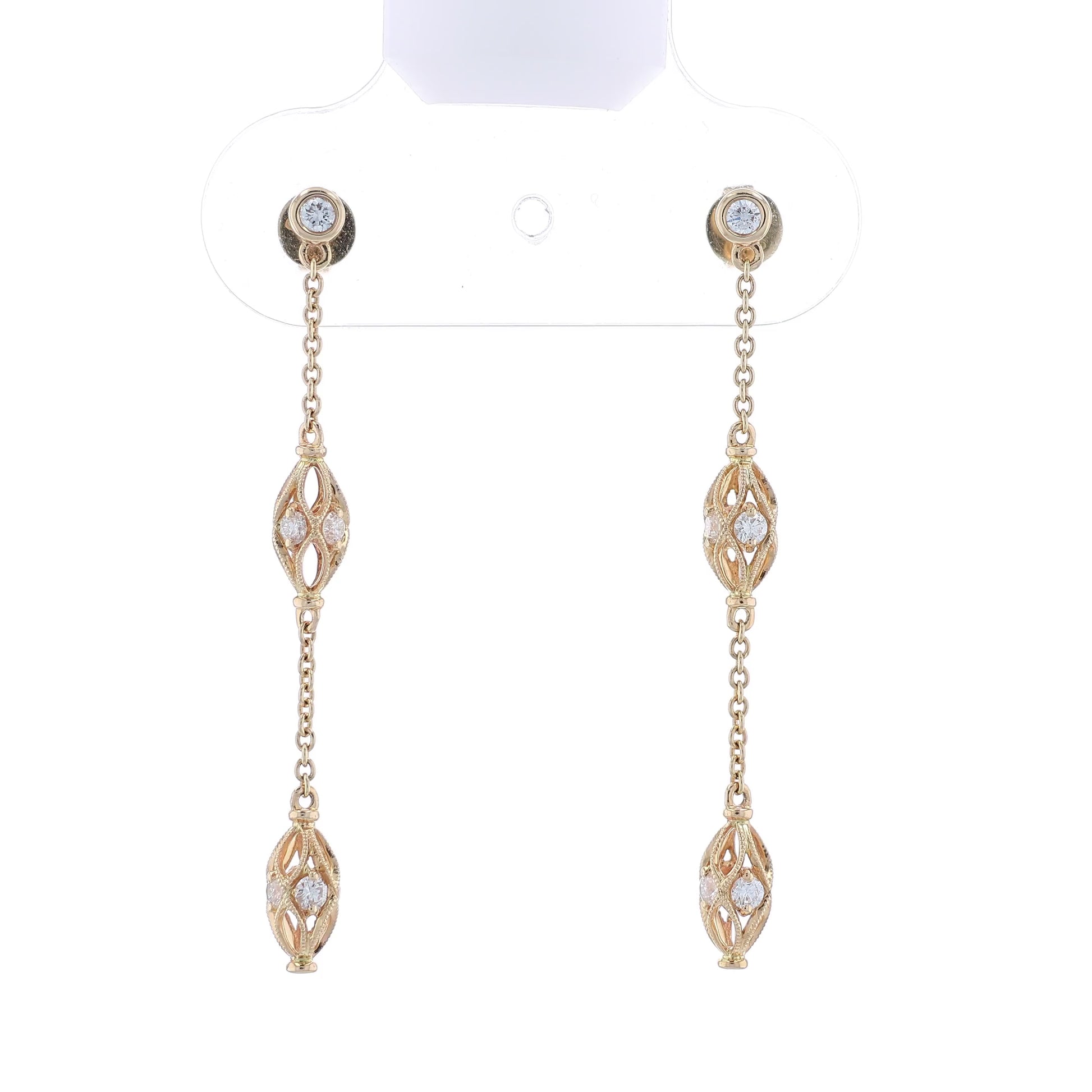 Gold dangle earrings with diamond accents on a white background