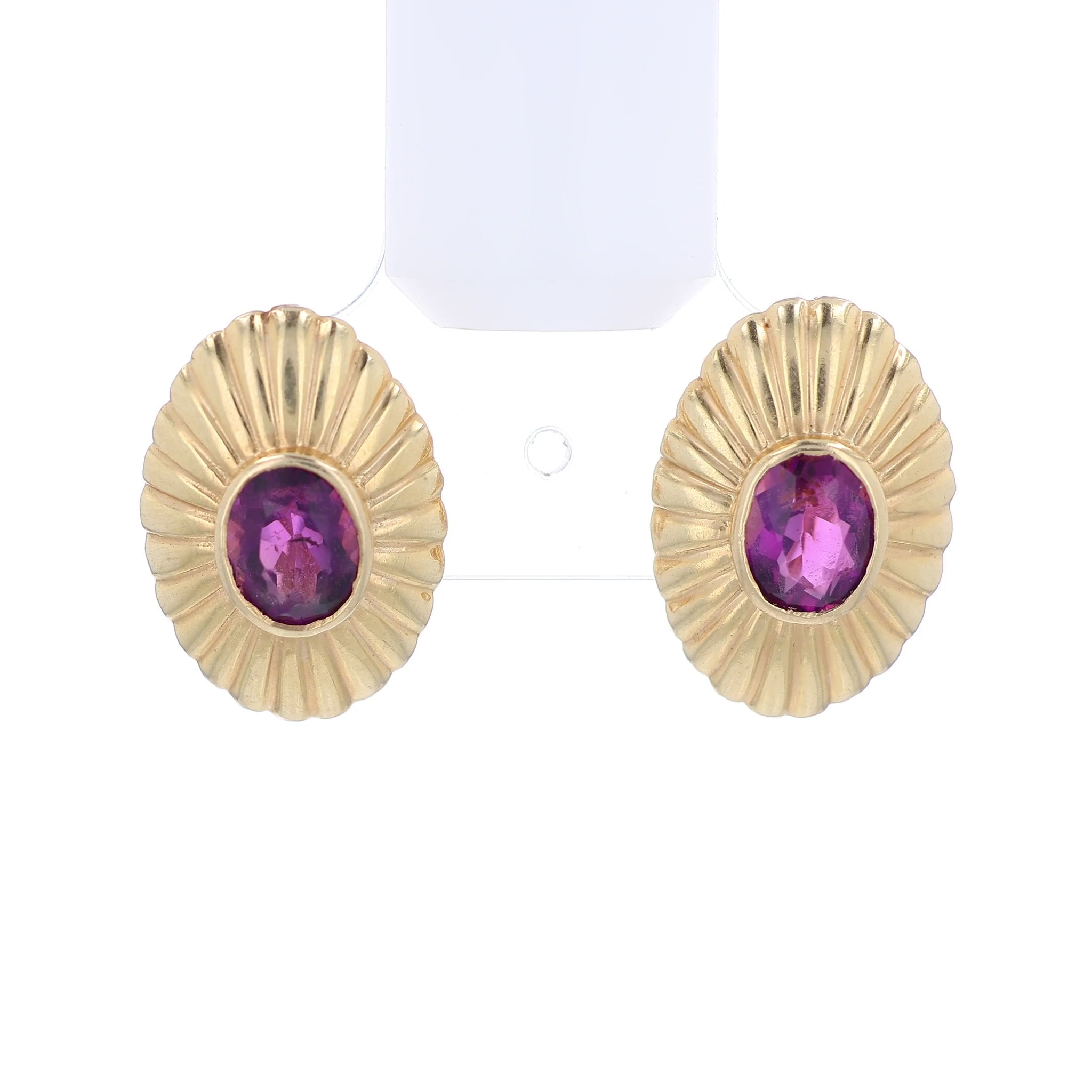 Yellow gold ribbed frame design oval amethyst stud earrings on a white background