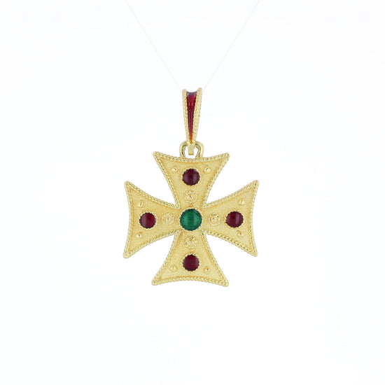 Yellow gold textured cross pendant with red and green glass accents on the face and red enamel on the bail on a white background