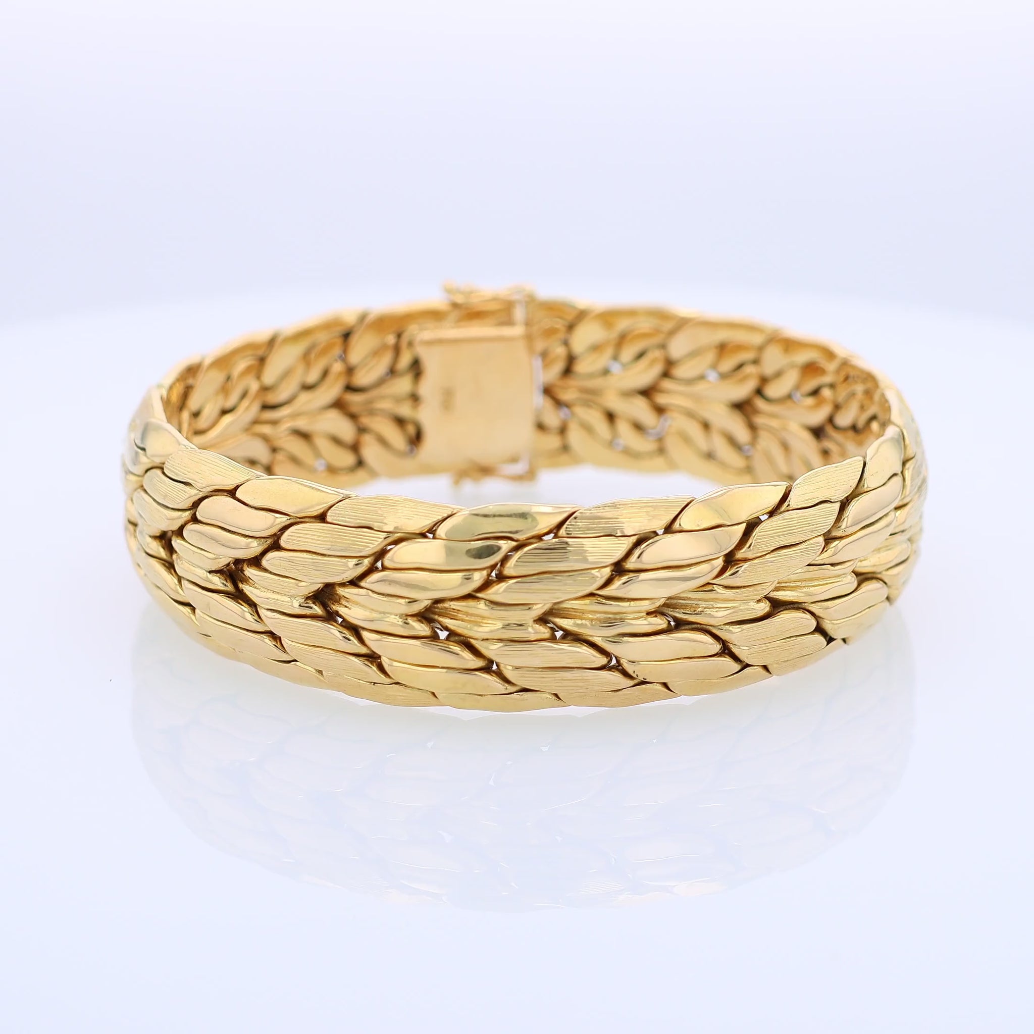 360 degree video of a brushed and polished yellow gold bracelet on a white background