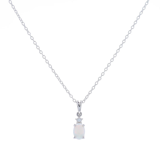 White gold oval opal and diamond pendant necklace on a white background