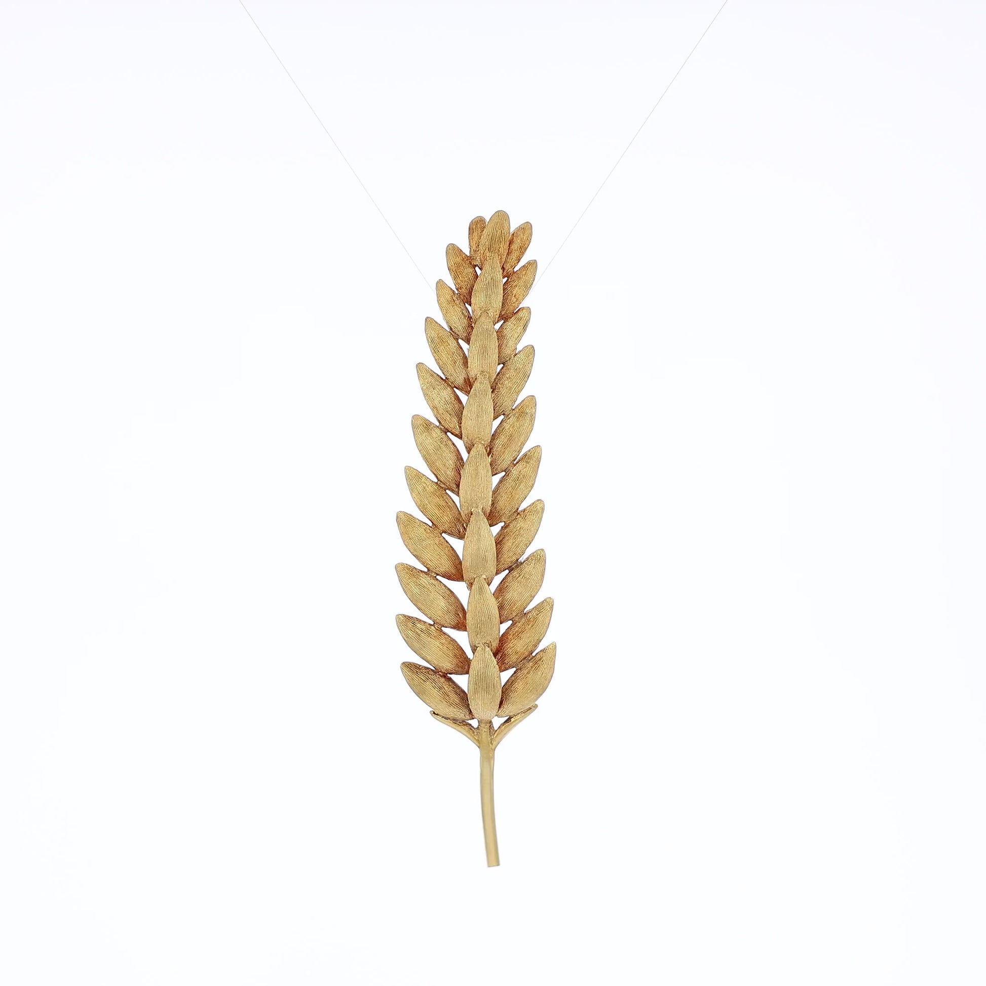 Brushed yellow gold wheat stalk pin on a white background