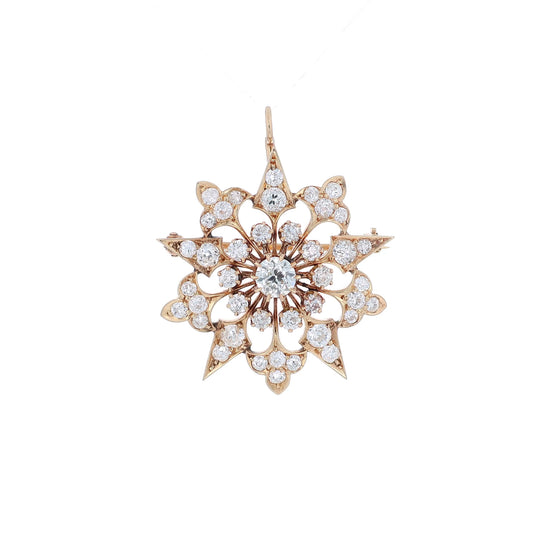Yellow gold modular pin or pendant with diamond accents on a white background