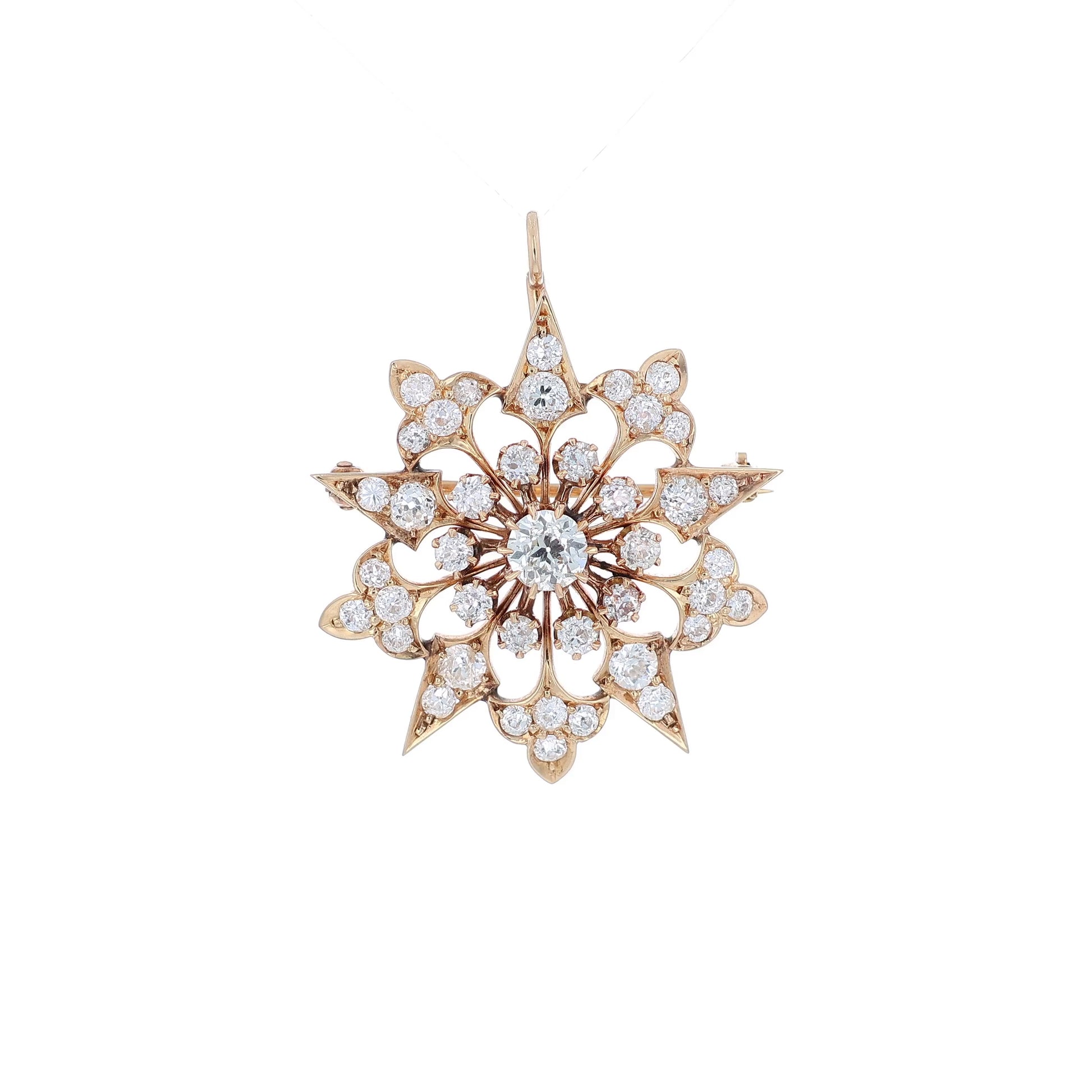 Yellow gold modular pin or pendant with diamond accents on a white background