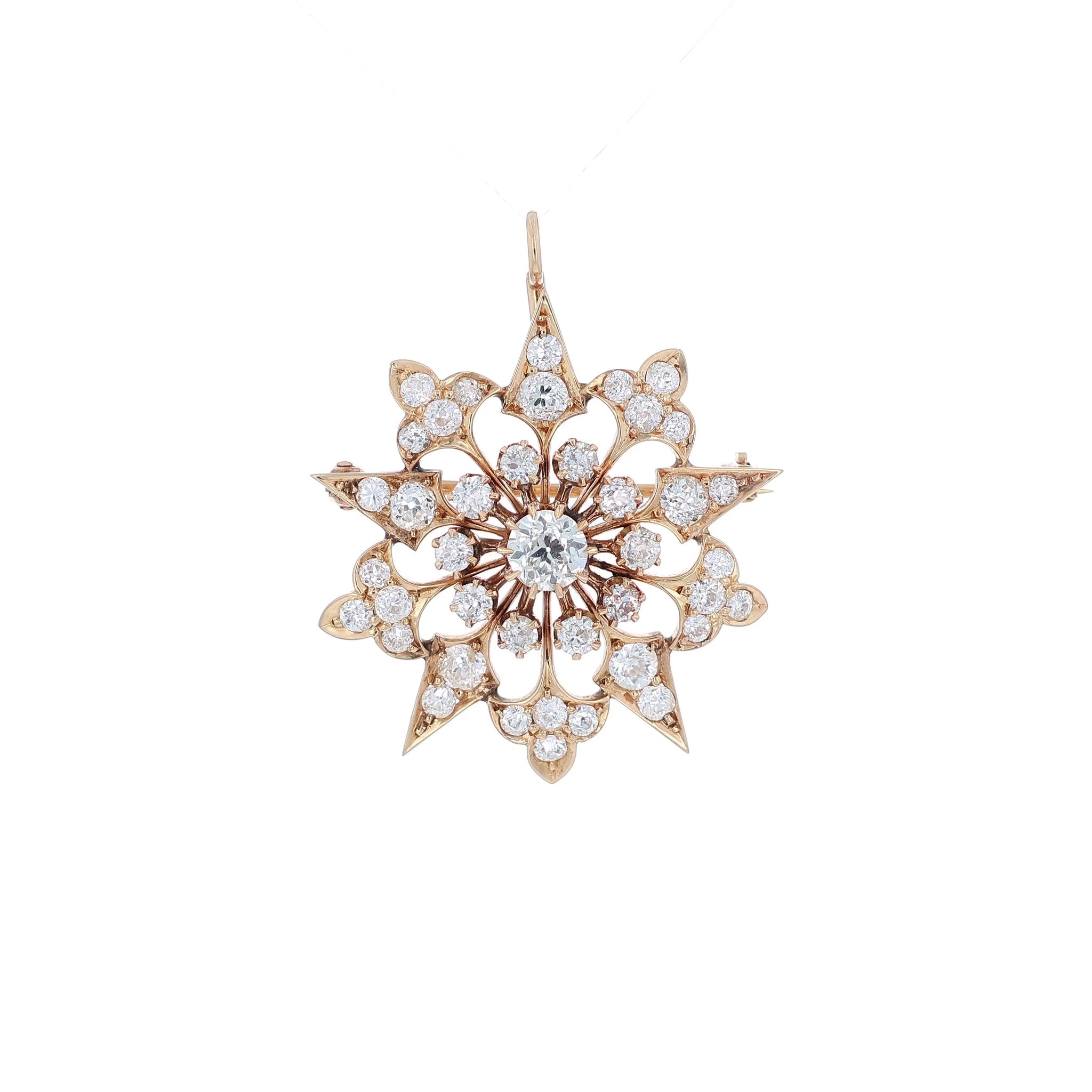 Yellow gold modular pin or pendant with diamond accents on a white background