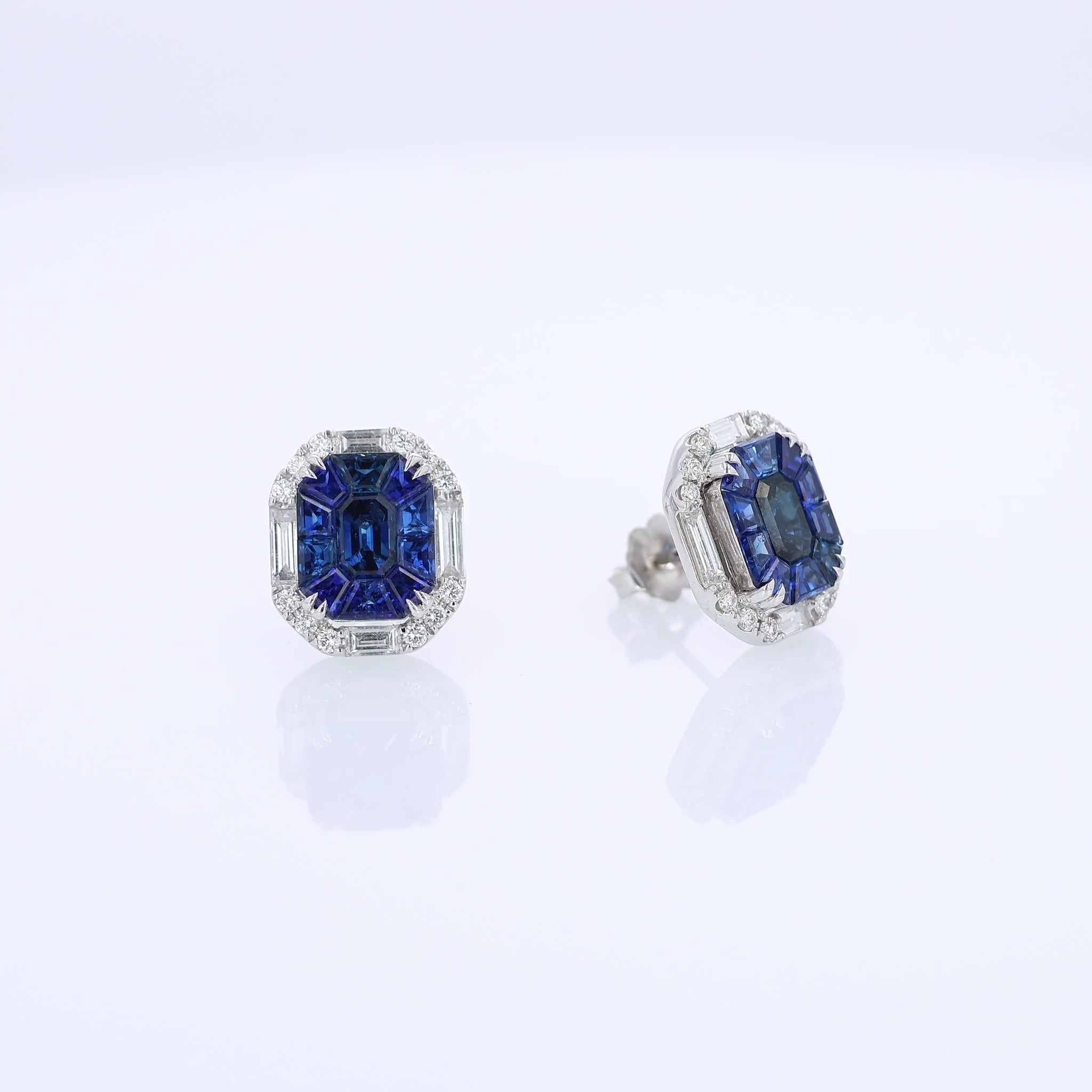 Sophia D. white gold stud earrings with sapphire center stones and diamond halos on a white background