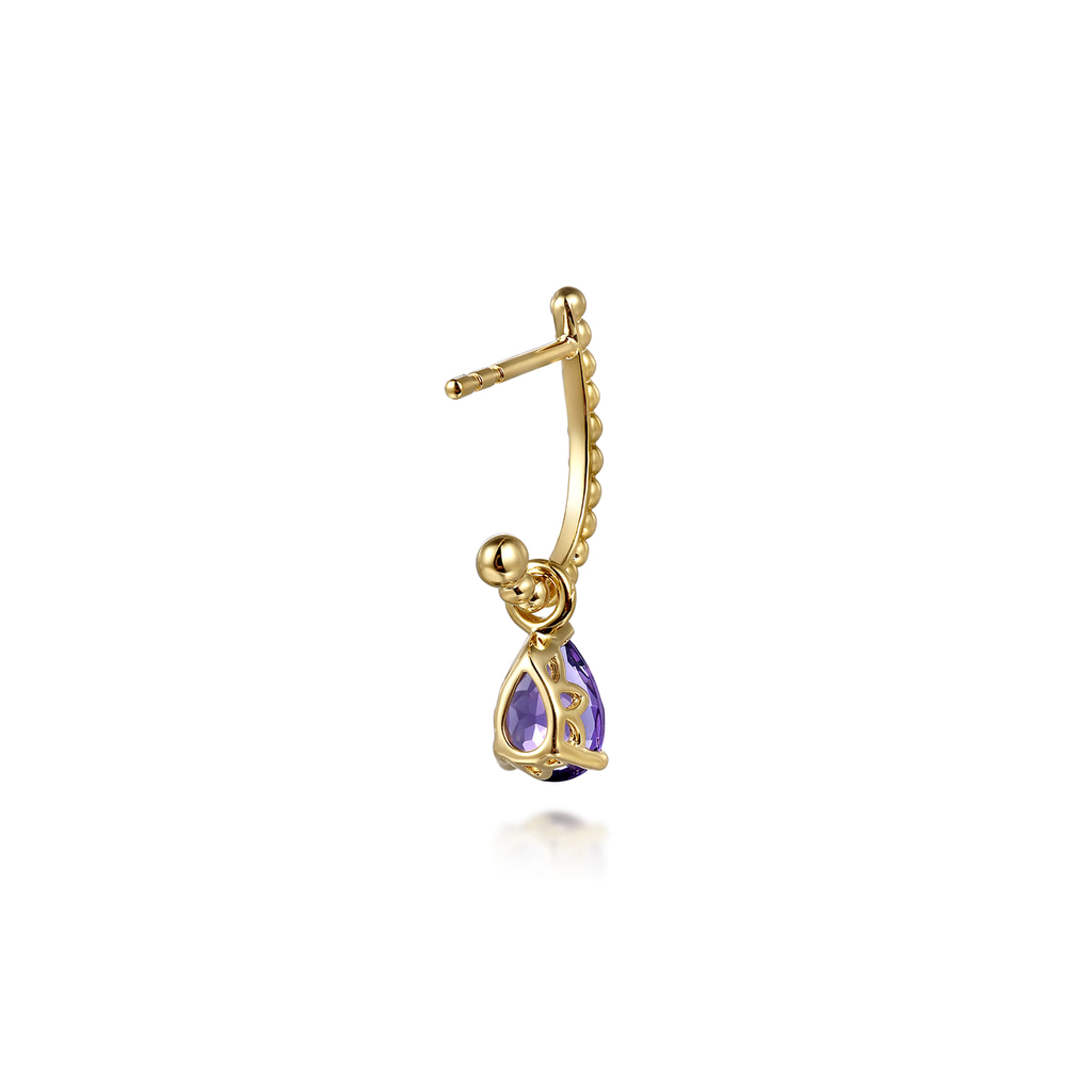 Gold earring with a purple gemstone on a white background