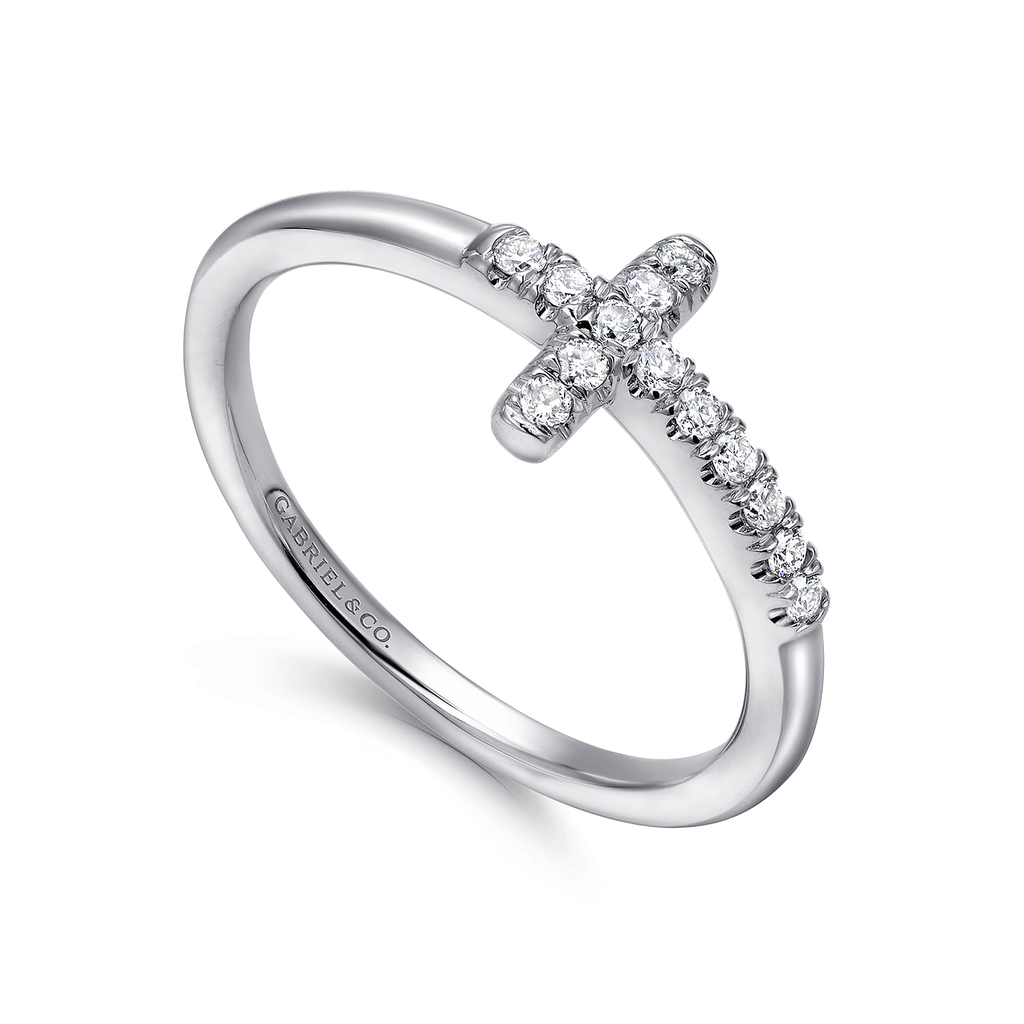 Silver ring with diamond cross design on a white background