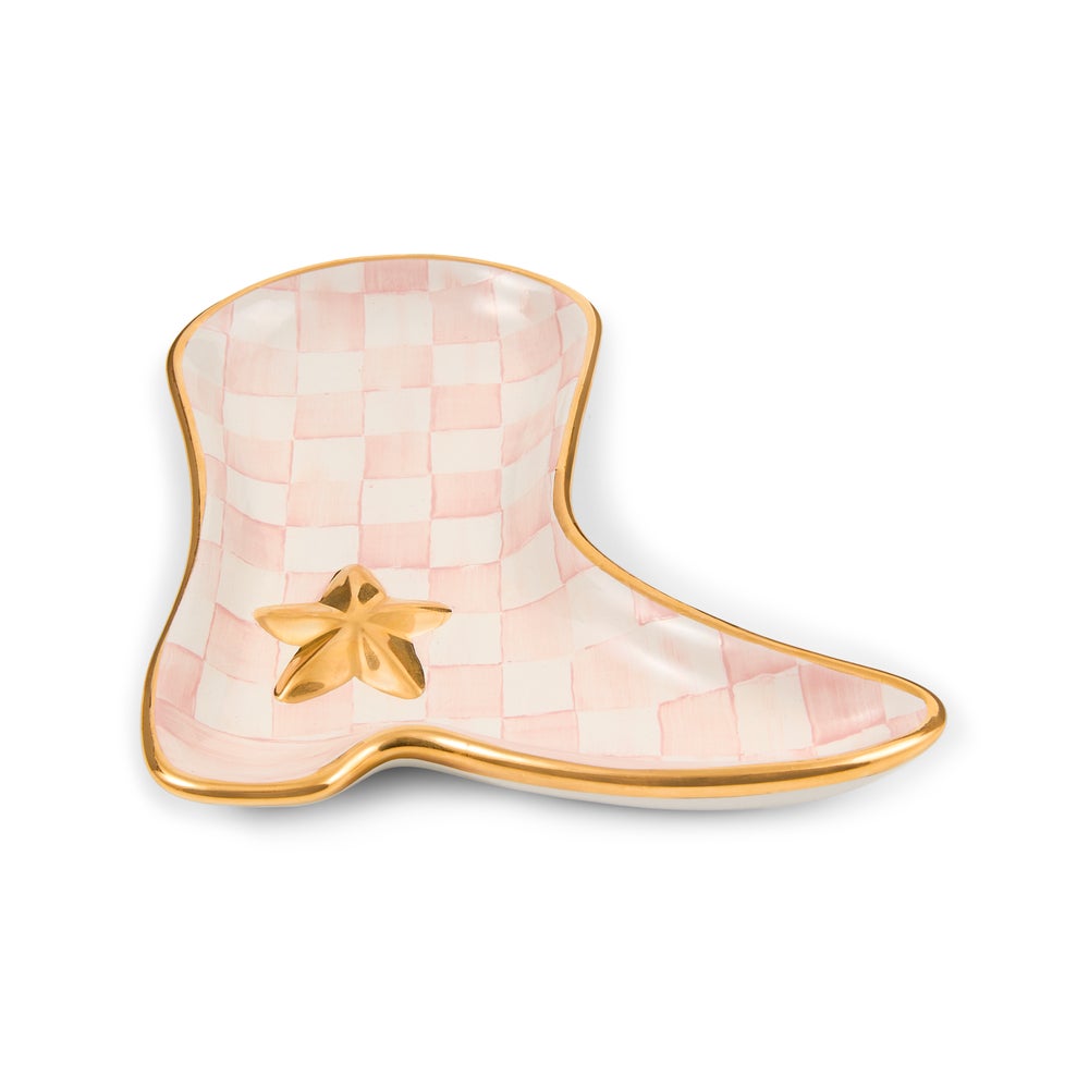 A novelty boot-shaped ceramic dish featuring a pink and white checkered pattern, a metallic gold border, and a small gold star accent on the front, set against a plain white background.