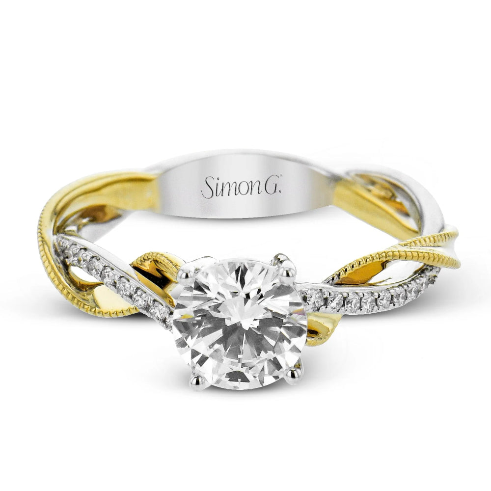 Two-tone gold and silver ring with a large diamond, branded 'Simon G'.