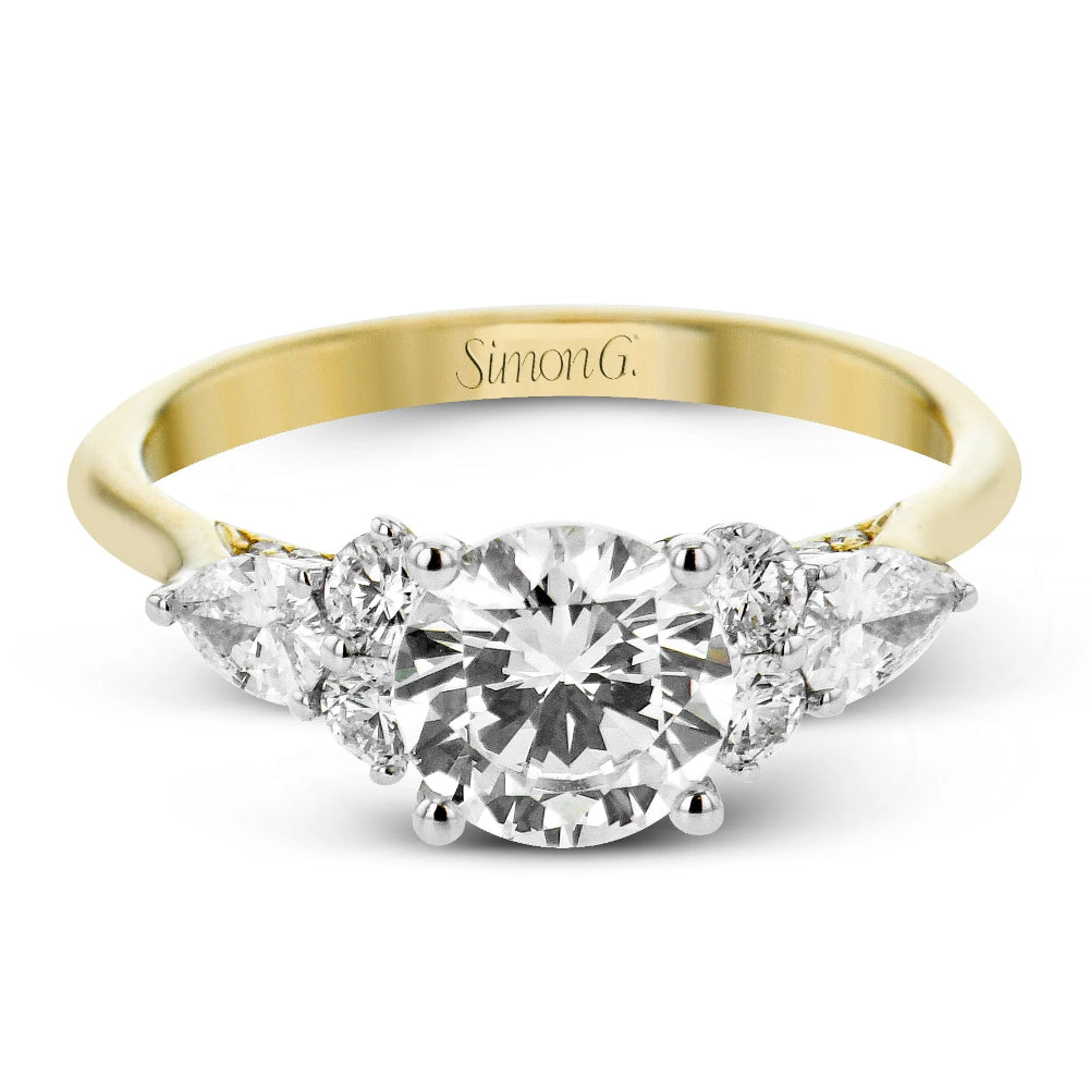 Gold ring with a diamond and pear-shaped gemstones on a white background, featuring the brand 'Simon G'.