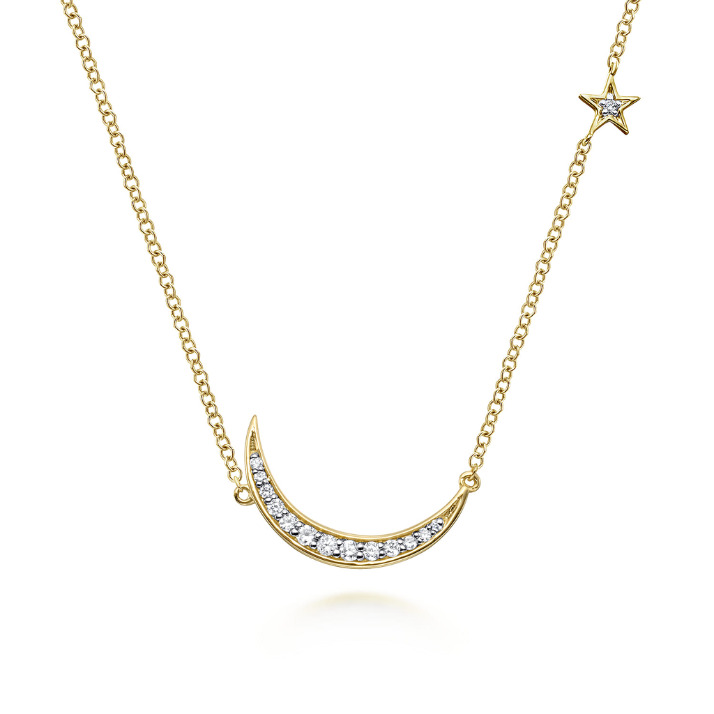 Gold necklace with a crescent moon and star pendant on a white background