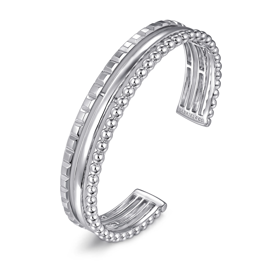 Silver bracelet with intricate design on a white background