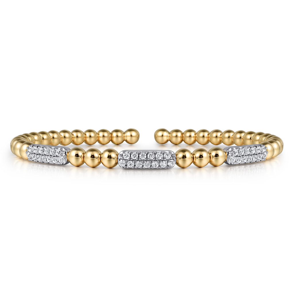 gold beaded bangle with clear stones on white background
