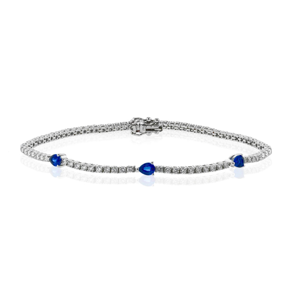 Silver bracelet with blue gemstones on a white background