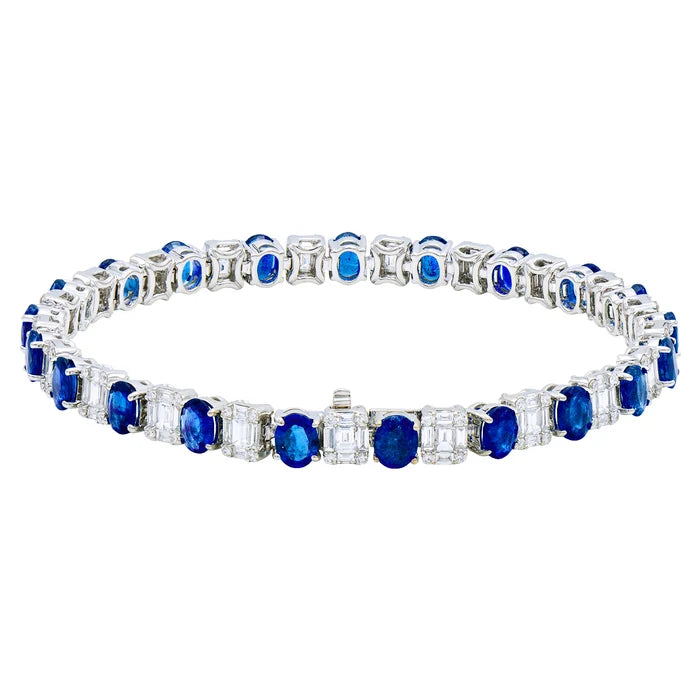 silver tone bracelet with blue and clear stones on a white background