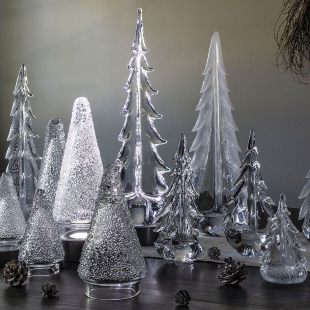 A collection of Simon Pearce trees on a table display. 