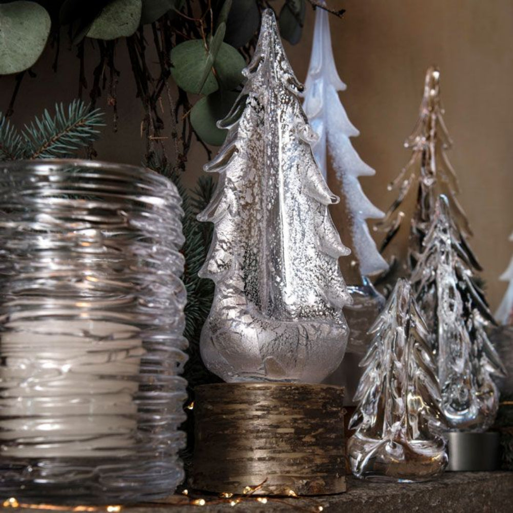 A collection of Simon Pearce trees and decor items on display. 