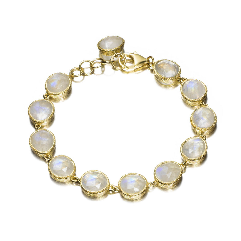 A gold bracelet featuring eight round, bezel-set white opal-like stones, displayed on a clean white background.