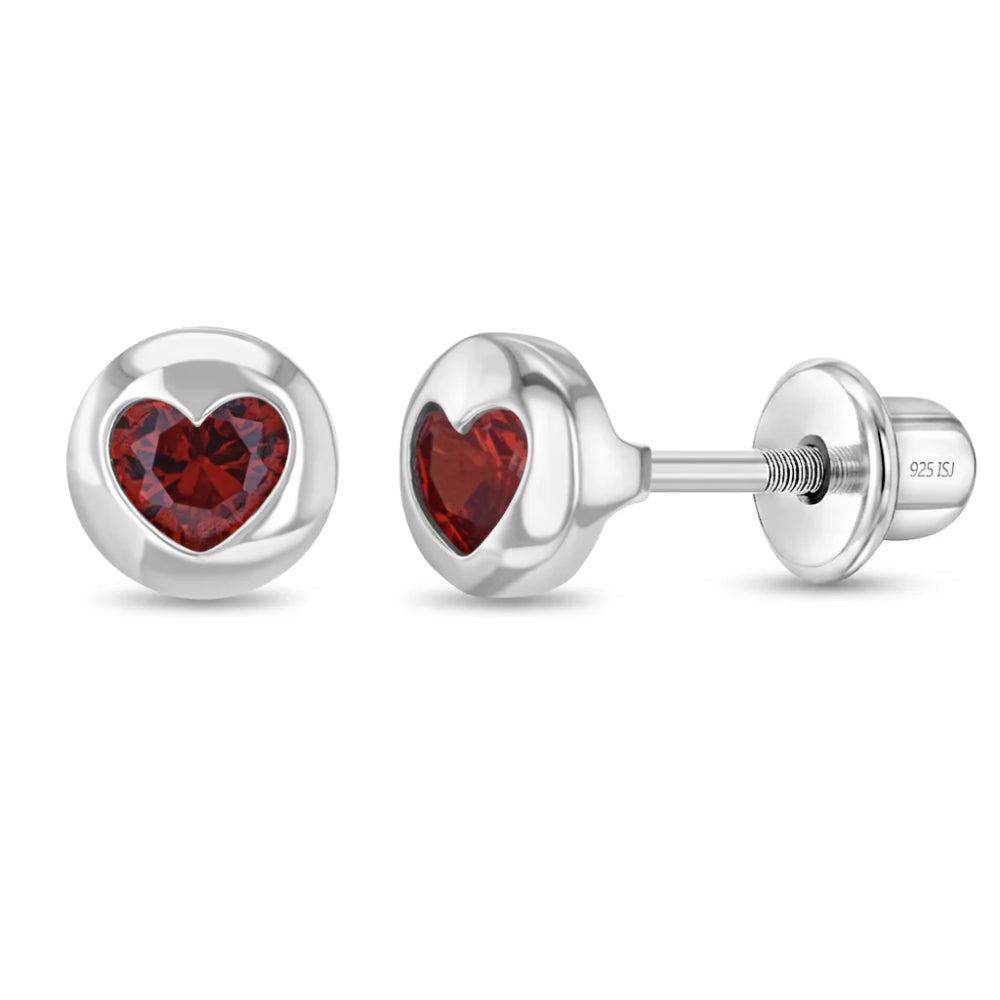 Circle shaped sterling silver stud earrings with a red colored heart shaped crystal in the center on a white background