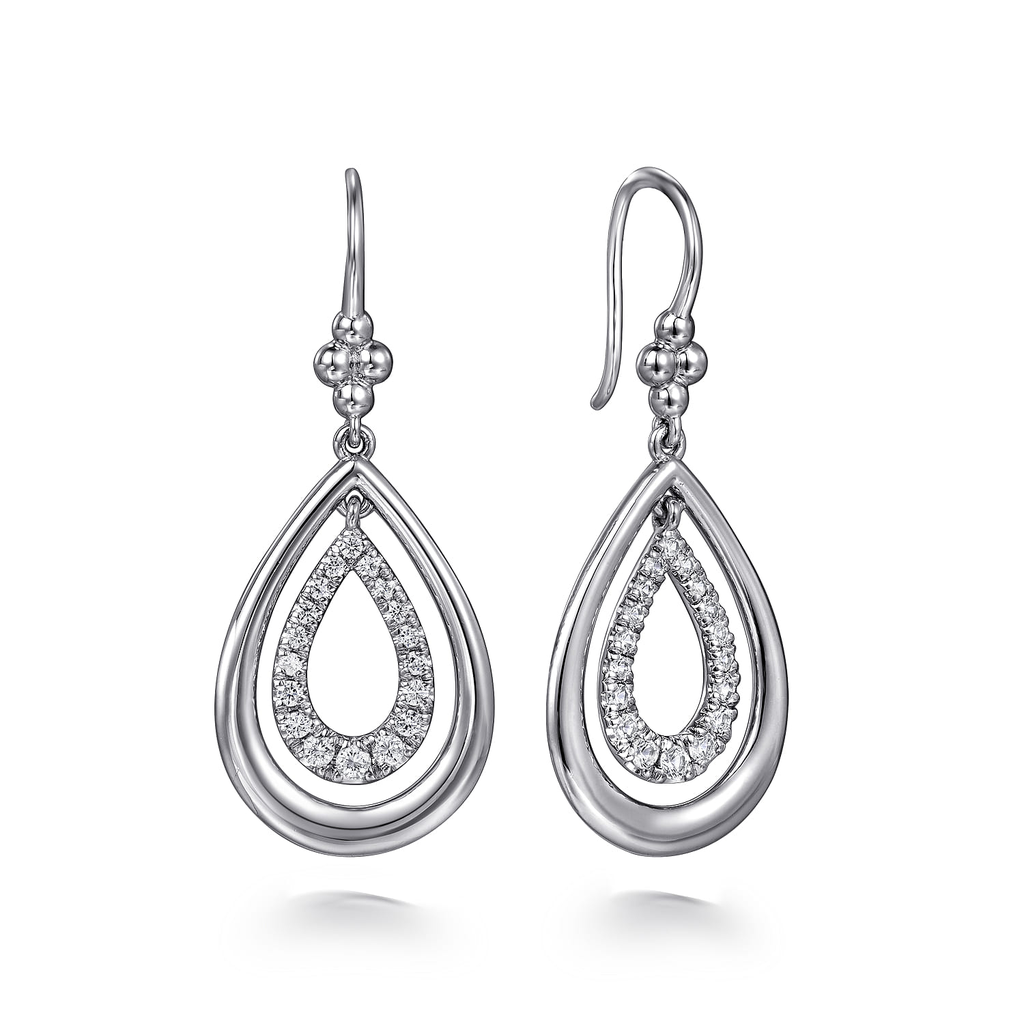 Pair of silver teardrop earrings with clear gemstones on a white background
