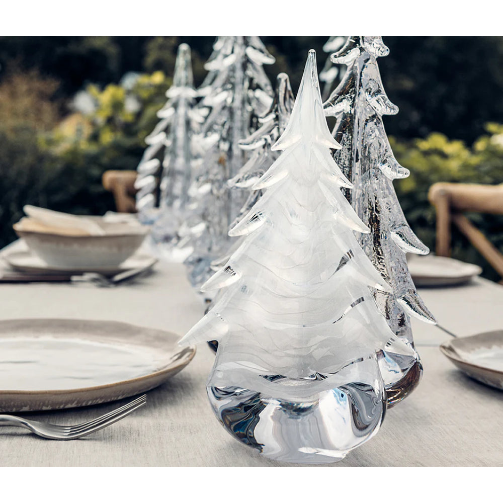 Crystal Christmas tree decorations on a table setting outdoors.