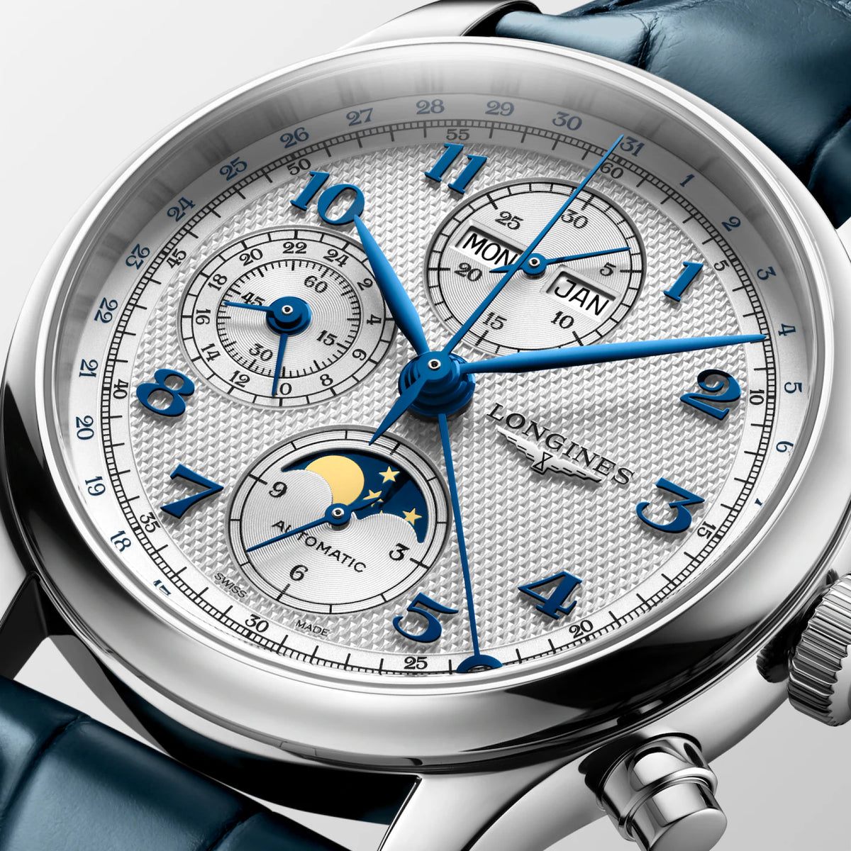 Close-up of a Longines Automatic MoonSwatch watch with a silver textured dial, blue hands and markers, and a dark blue leather strap.