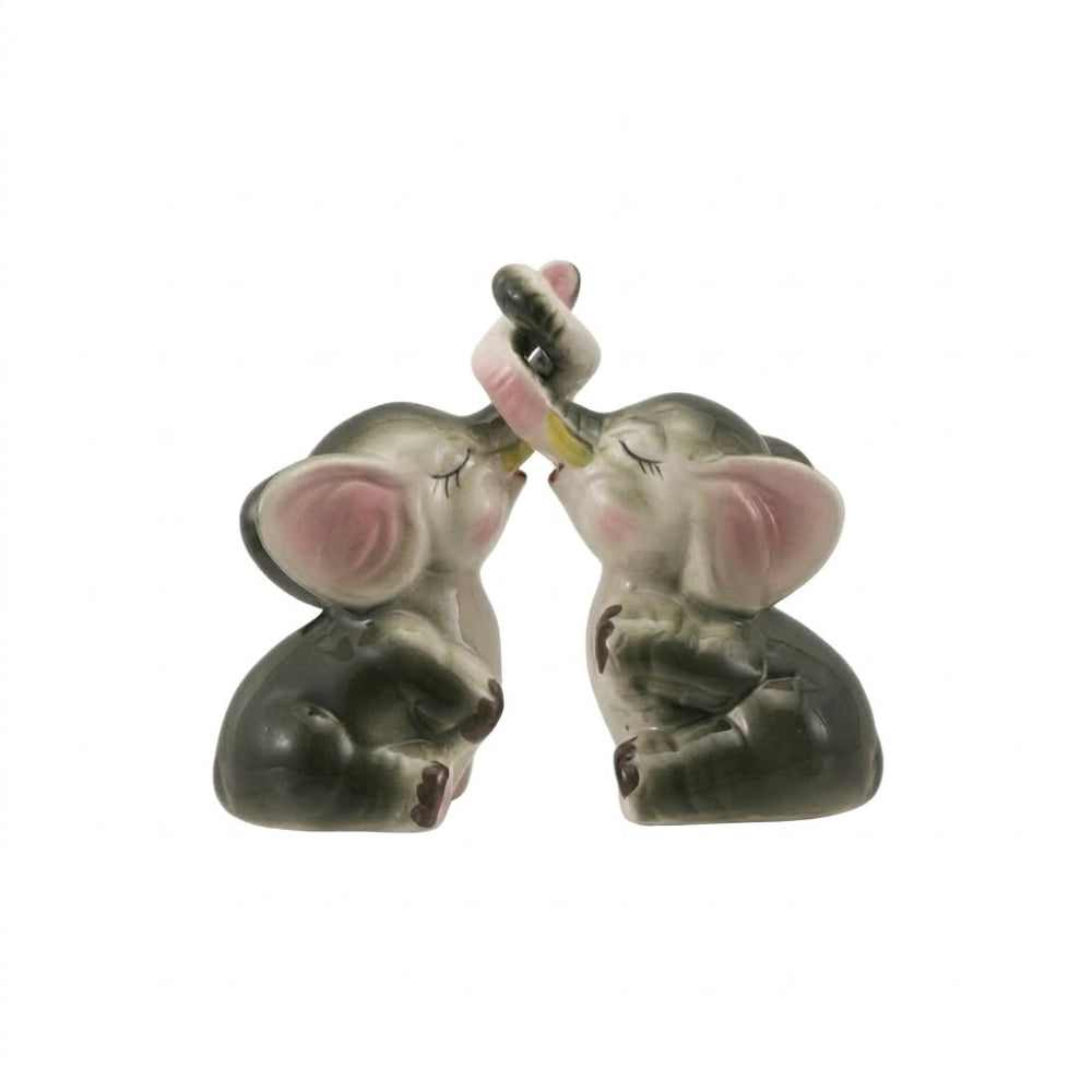 Two ceramic elephant salt & Pepper shakers on a white background