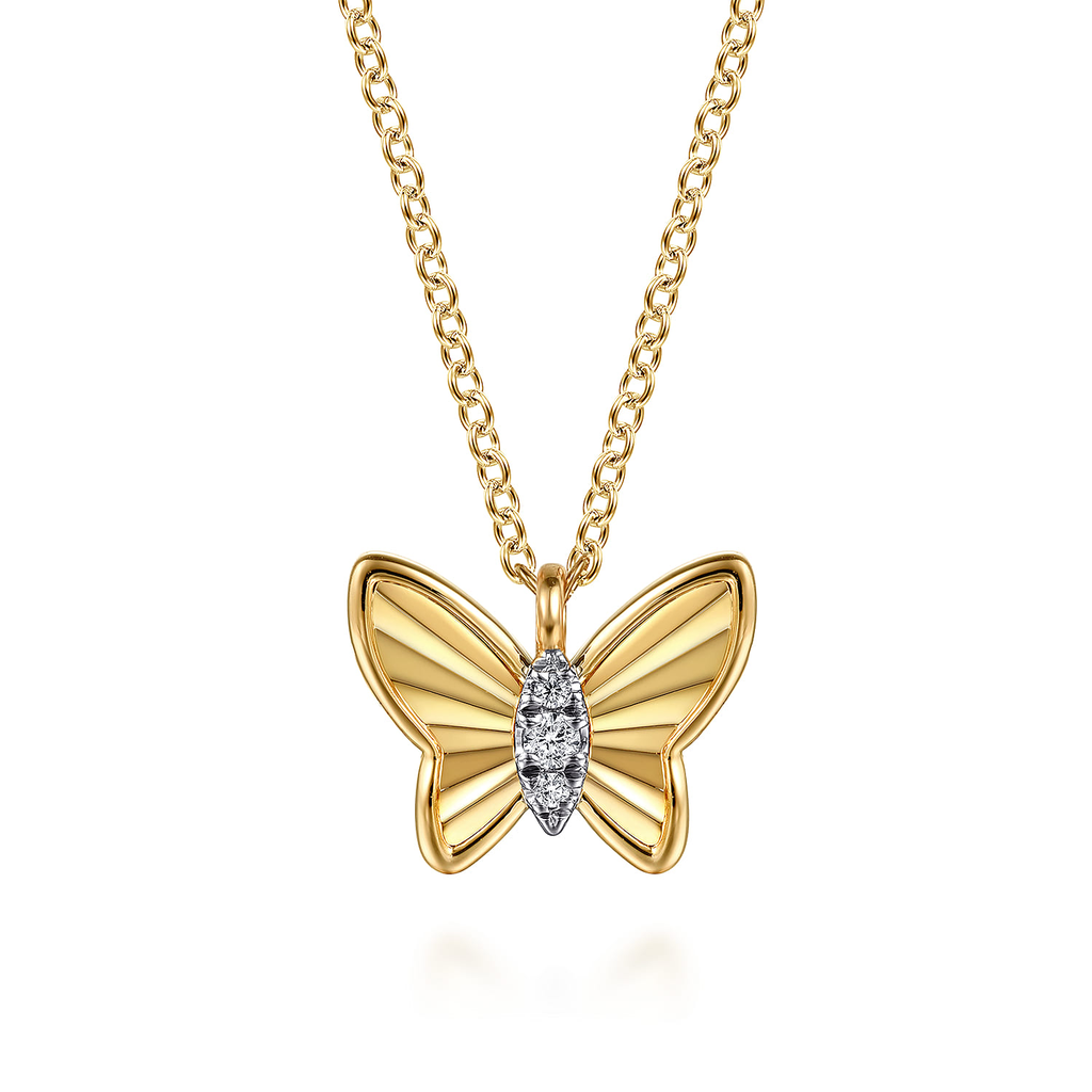 gold butterfly pendant on white background