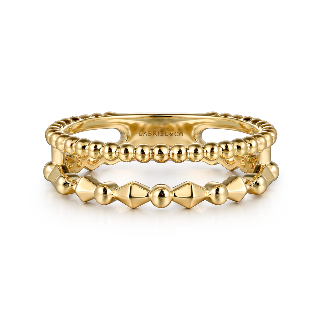 Stack of gold rings with 'GABRIELLE CO' branding on a white background