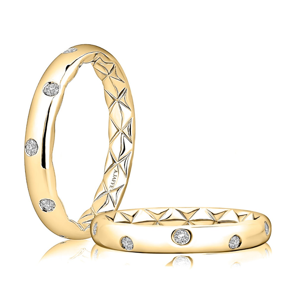 A pair of yellow gold rings with a textured geometric pattern and small round-cut diamond accents, displayed on a clean white background.