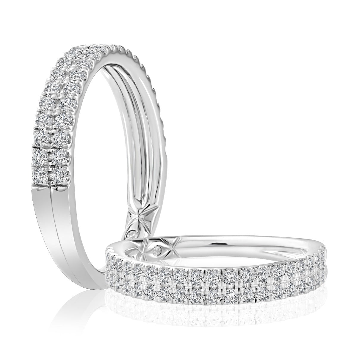 A pair of silver-toned eternity rings set with pavé diamonds, displayed on a clean white background with a soft reflection.