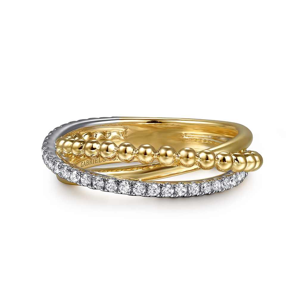 gold and silver ring with clear stones on white background