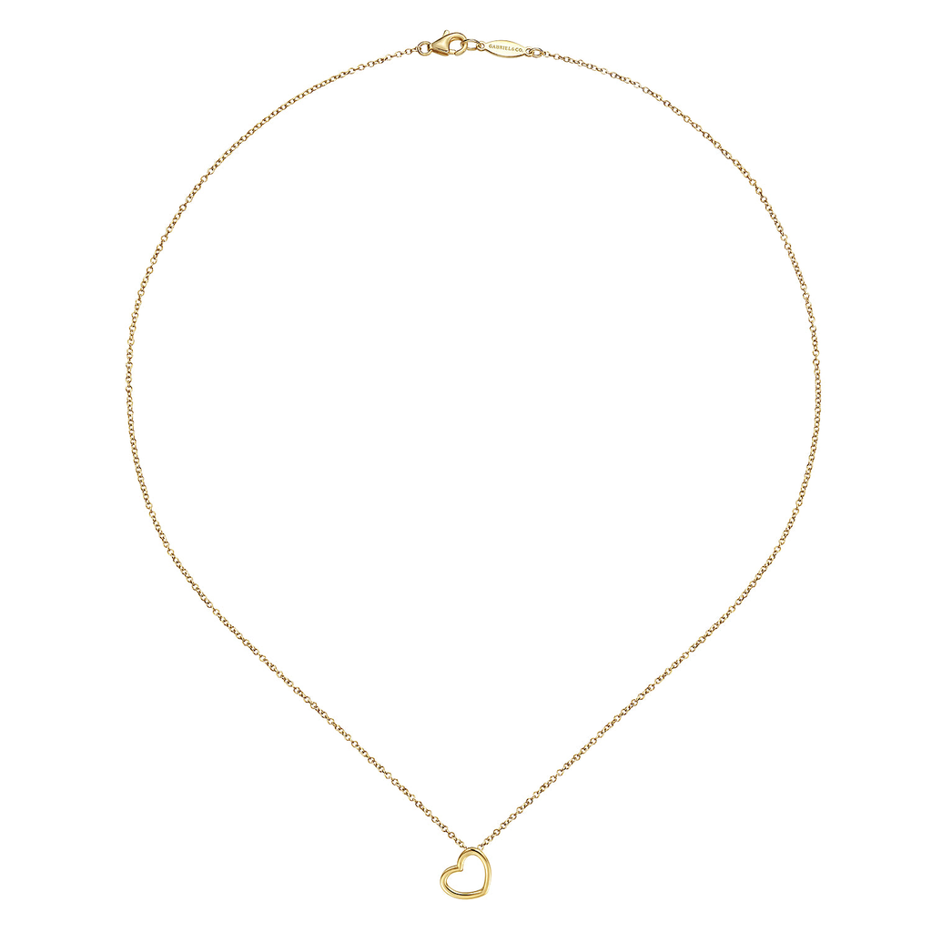 Gold necklace with a heart-shaped pendant on a white background