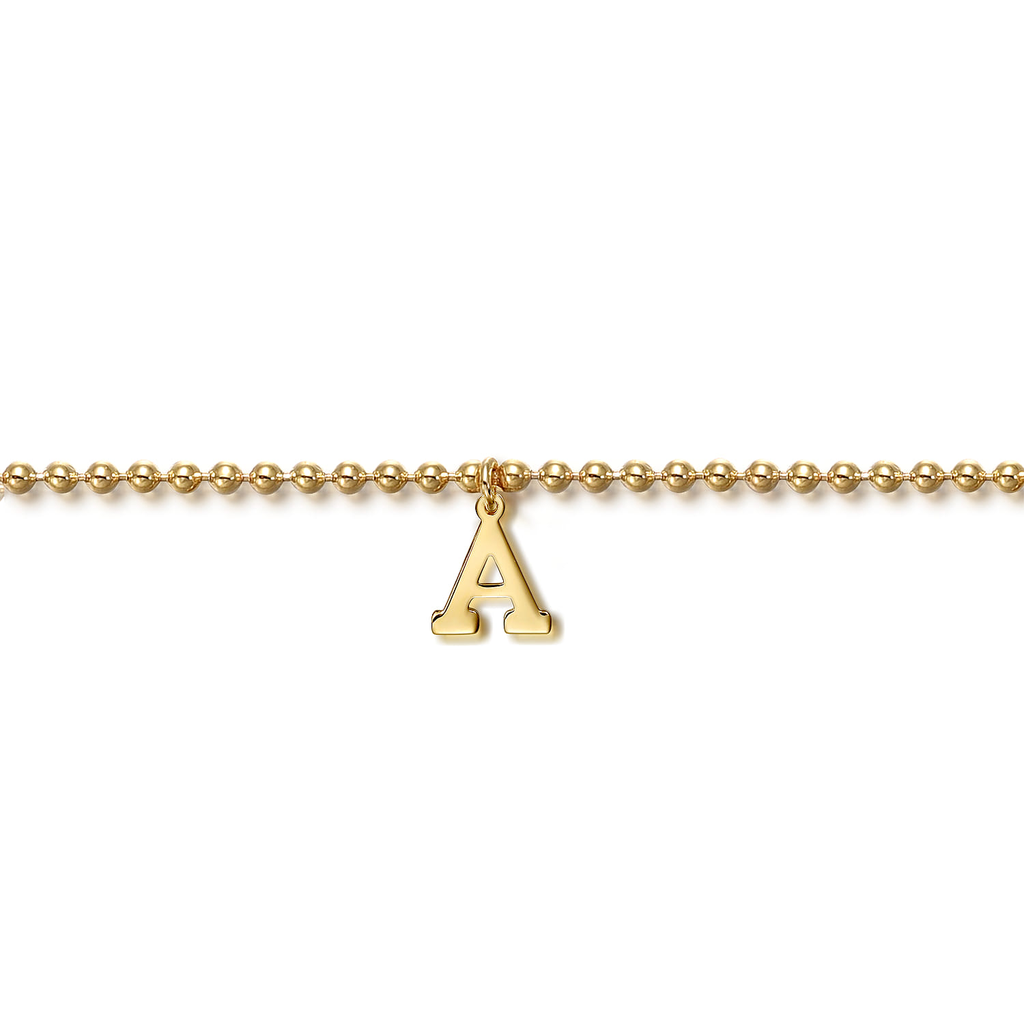 gold beaded bracelet with initial A drop on white background