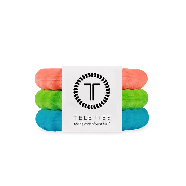 Stack of colorful hair ties with Teleties packaging on a white background