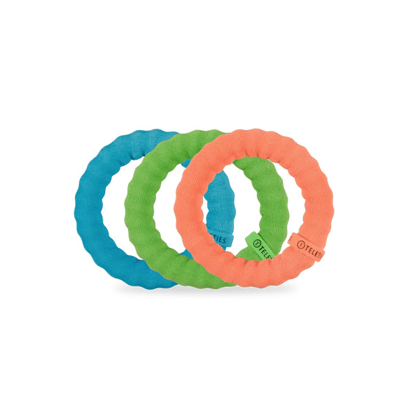 Three colorful rubber hair ties on a white background